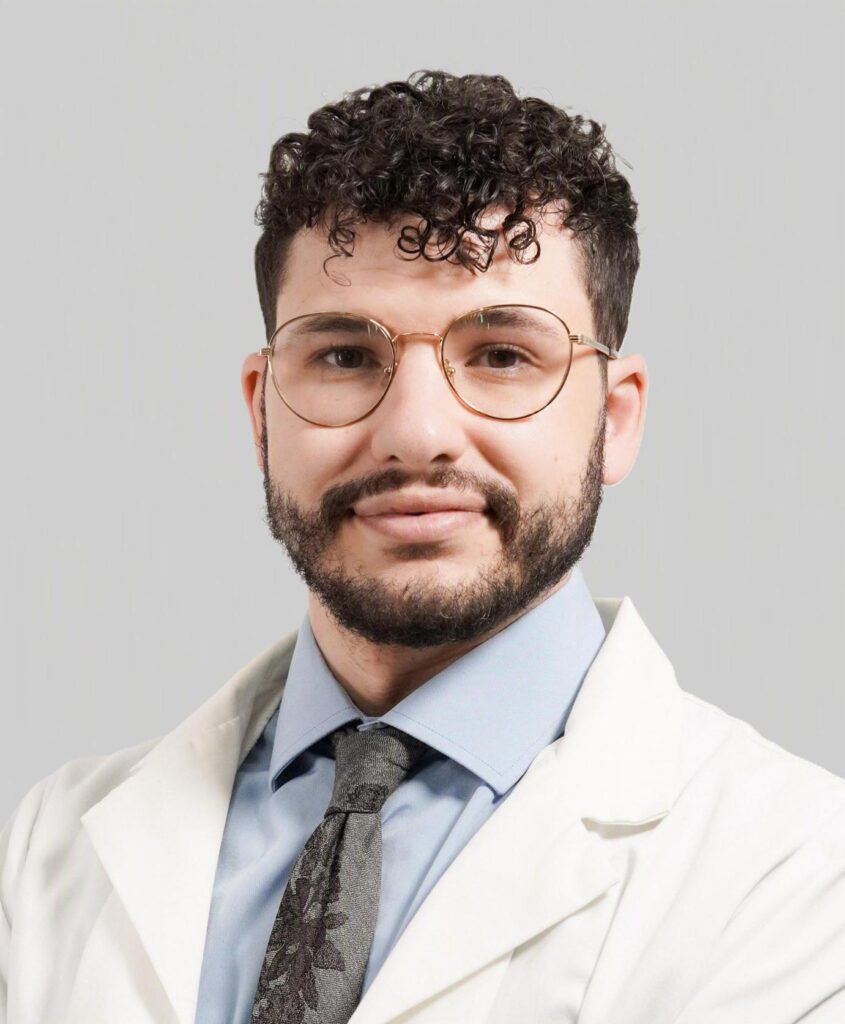 Martin S. Hoff smiling in a professional headshot wearing a white coat
